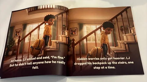 Printed copy of The Worry Backpack open to the pages where LJ drags his backpack up the stairs